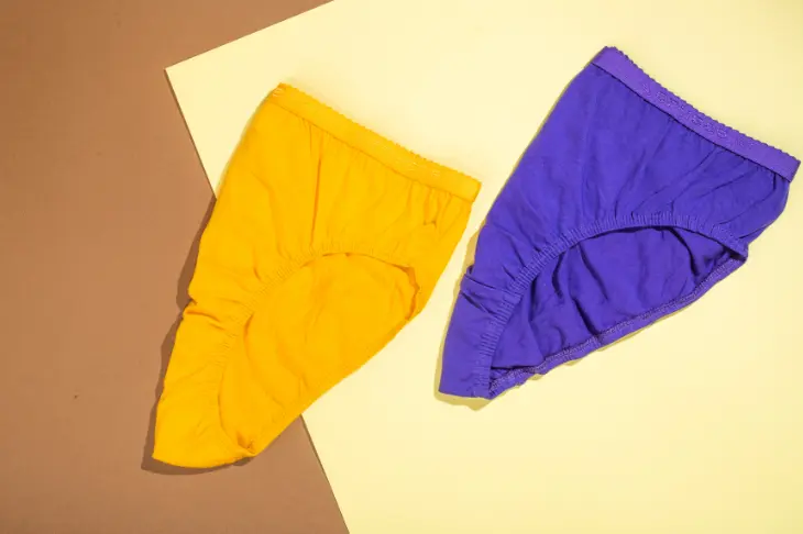 A pair of purple & yellow underwear, perfect for adding a pop of color to your ensemble, perfectly captured in photos.