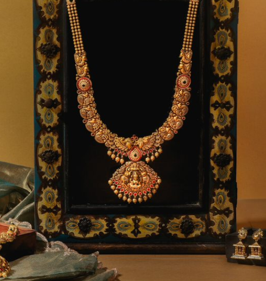 An image showcasing an exquisite set of gold necklaces and earrings, displaying intricate and elaborate designs.