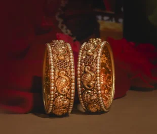 Gold bangles with intricate designs, a timeless addition to your collection captured in a brilliant photography