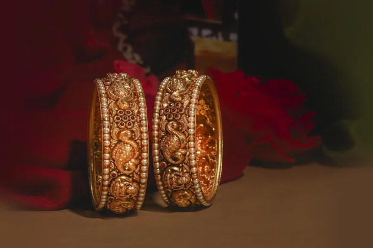 Gold bangles with intricate designs, a timeless addition to your collection captured in a brilliant photography